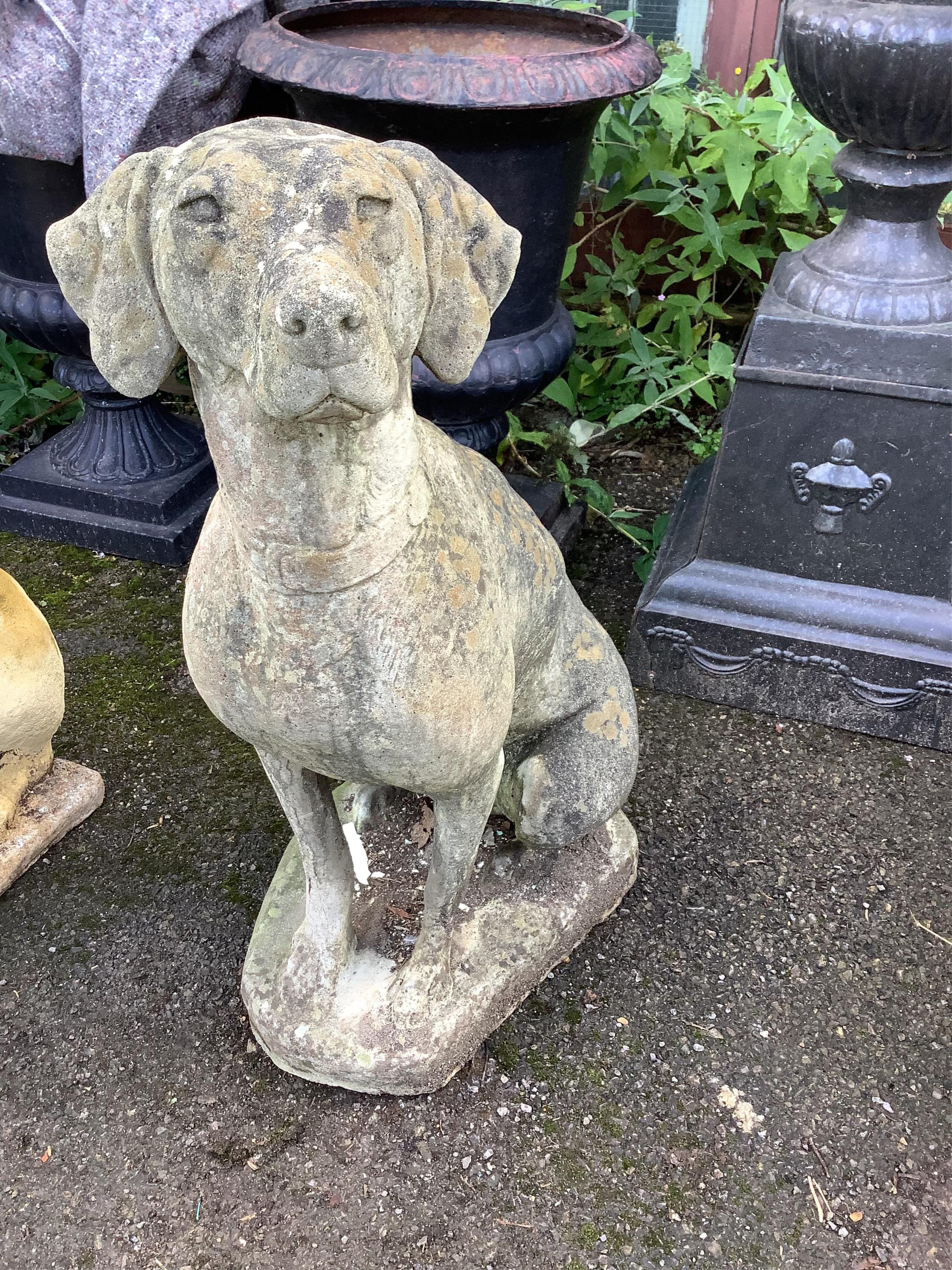 A reconstituted stone model of a seated hound, height 88cm. Condition - weathered, otherwise good